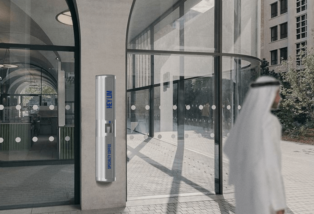 HEYLIM autonomous coffee kiosk installed in outdoor plaza with contemporary architecture in UAE